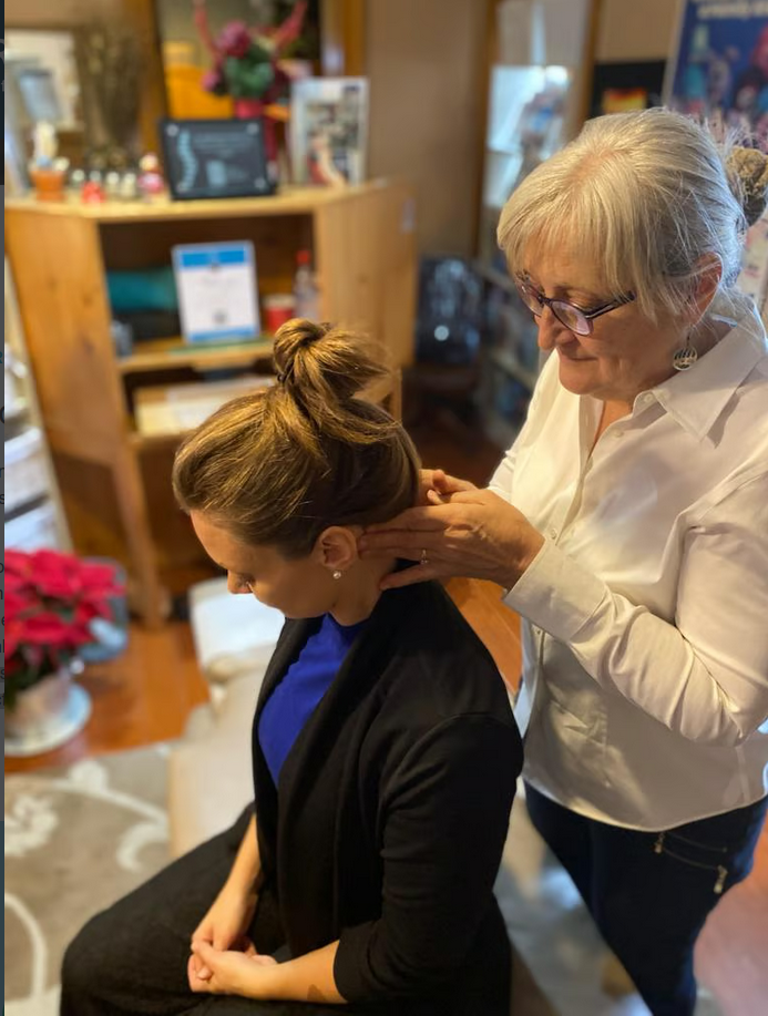 chiropractor treating patient with neck pain